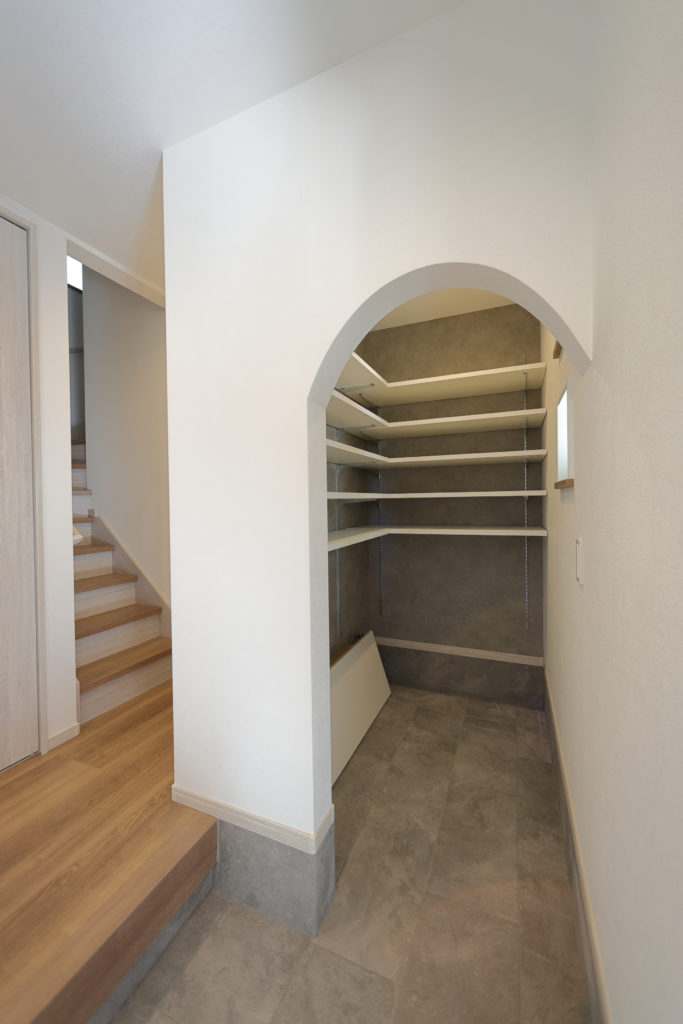 枚方市村野東町の家：アールの垂れ壁の土間収納（シューズクローク）